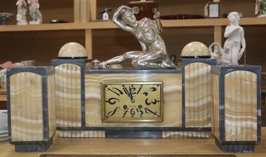 An Art Deco grey and cream marble clock garniture, with figural surmount height 34.5cm